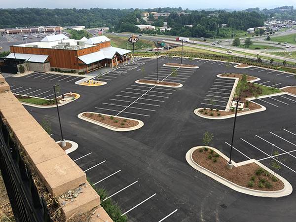 Aerial view of a commercial parking lot with landscaped islands