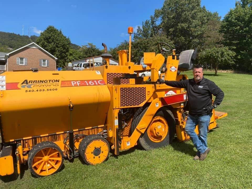 Crew member beside an Arrington Paving paver