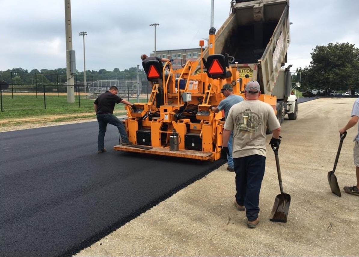 Arrington crew laying fresh asphalt behind a paver