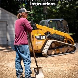 Crew member with a skid steer on a gravel site
