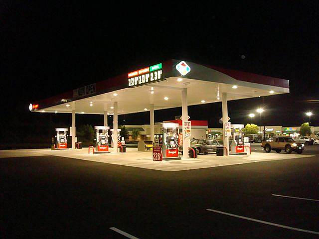 Gas station at night with a freshly paved lot