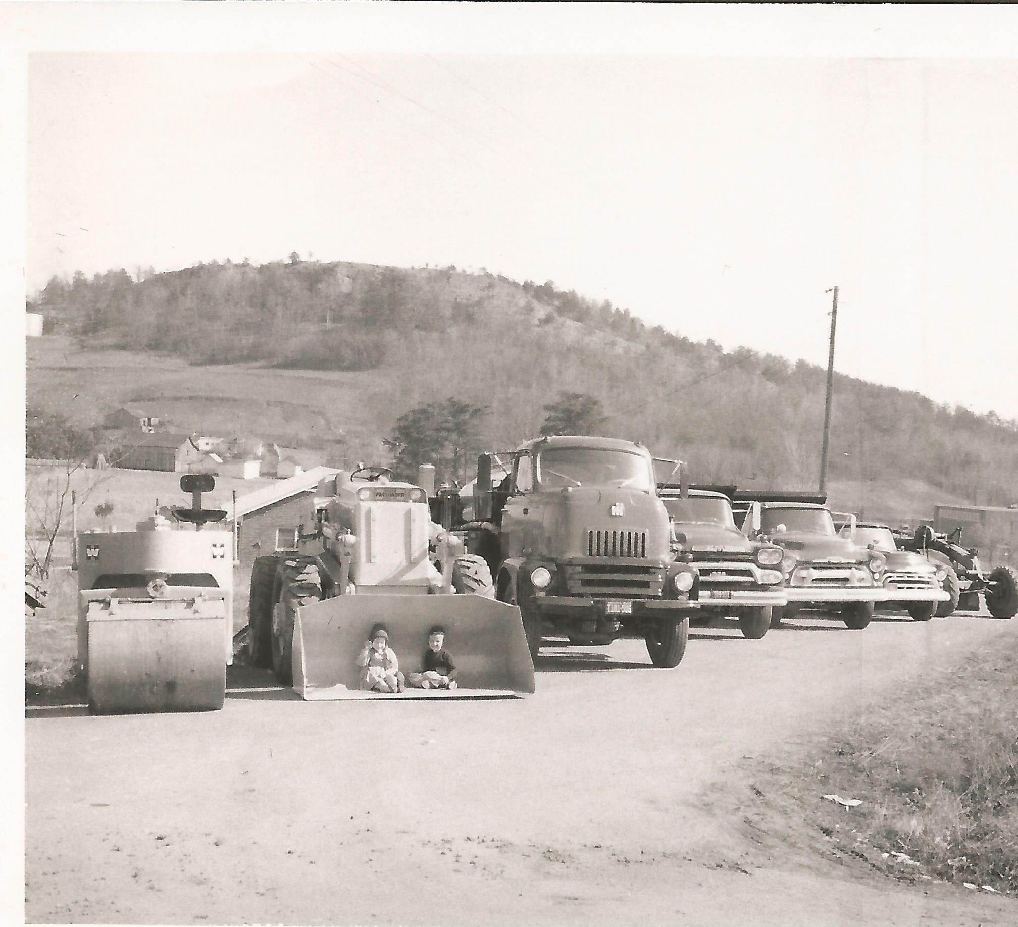 Vintage black-and-white photo of early Arrington Paving equipment